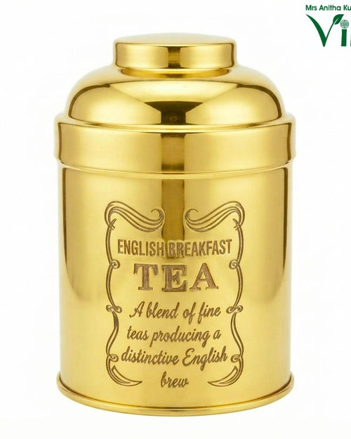 Storage Container, a polished gold-toned round container with an ornate border around etched text on the front
