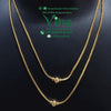 Impon 2 Layor Chain, two gold-toned snake chains, each featuring a centered round textured bead, displayed against a black background