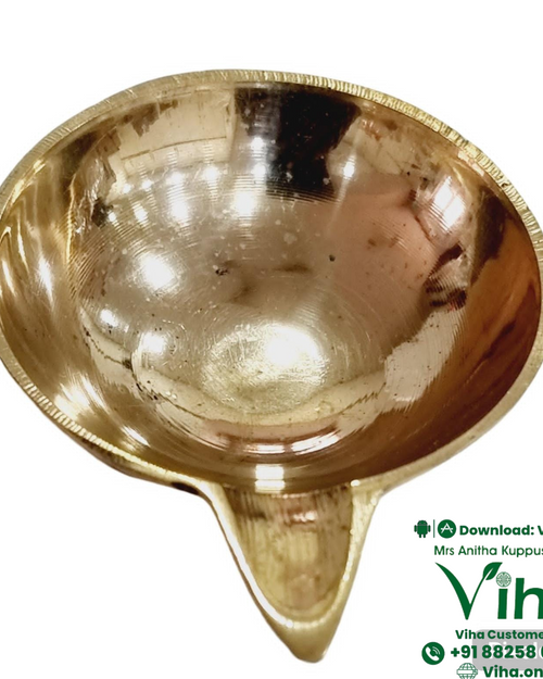 Heavy agal vilakku in brass, deep round oil bowl drawn out into a single pointed wick spout