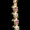 Impon Mugappu Chain, a vertical, gold-toned metal chain features a patterned bead and alternating red and clear round stones within spiraling elements