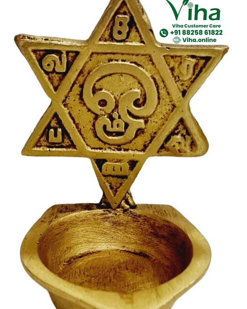 Shatkona deepam in brass, six-pointed star plaque with inscribed letters above a heart-shaped oil bowl