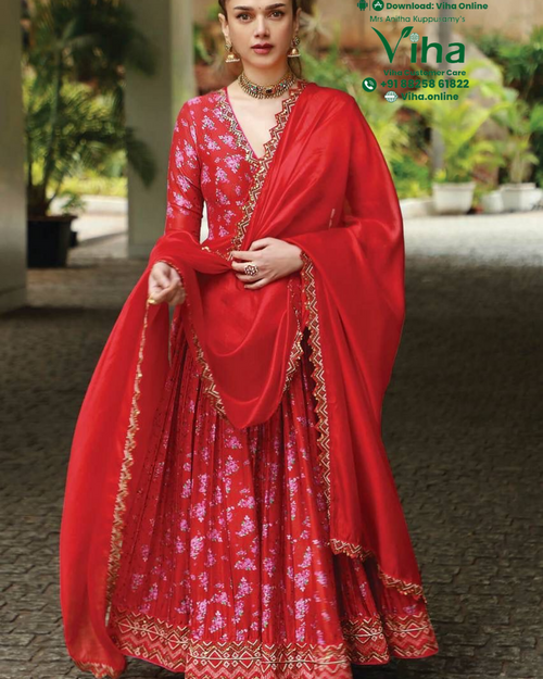 Trendy Readymade Kurti Set, a woman wearing a bright red floral-print gown with gold-toned embellished borders and a matching sheer dupatta