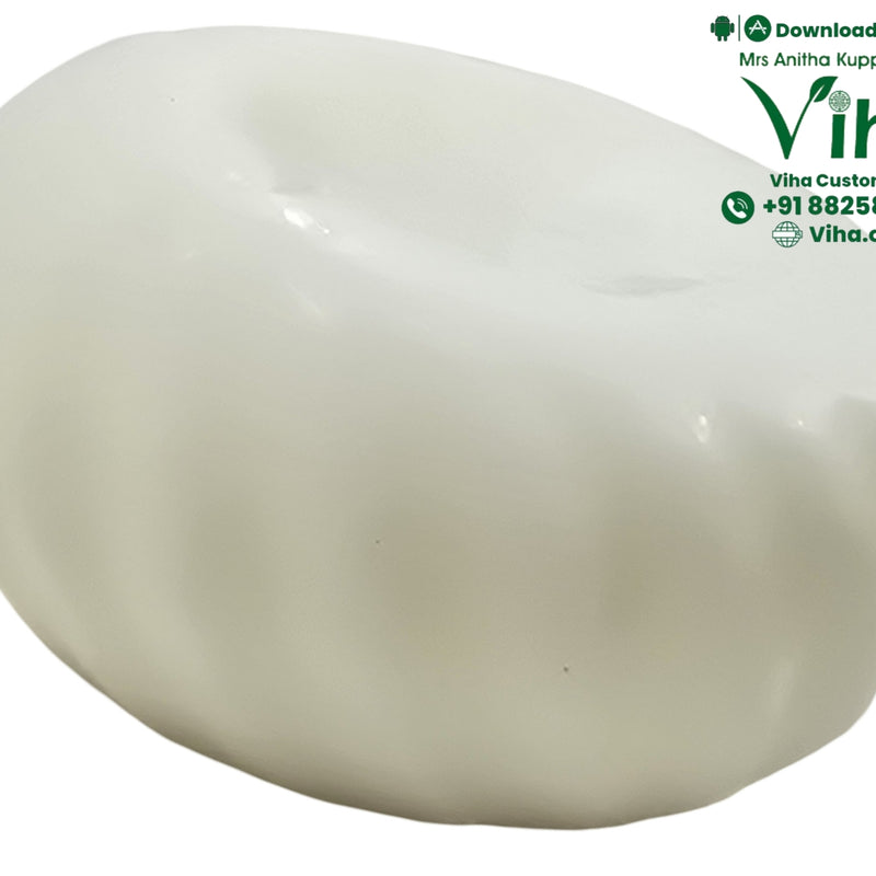 Viha's Butter Soap - Handmade, a glossy white oval object with diagonal fluted ridges curving along its rounded surface
