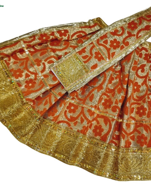 Amman Pavadai Set, an orange and gold-toned patterned fabric garment featuring floral motifs and shiny metallic borders