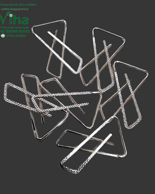 Saree Pin, several silver-toned safety pins with triangular textured loops, scattered together