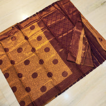 Soft Silk Saree With Blouse, a folded purple and gold-toned fabric featuring patterned panels with floral and geometric motifs