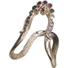 Impon Vanki Ring, a gold-toned textured metal ornament featuring a winding ribbon form inset with clear, red, and green stones