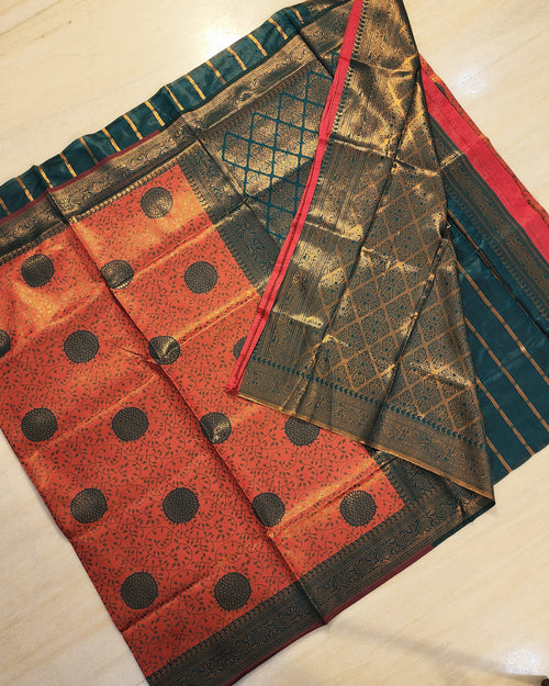 Soft Silk Saree With Blouse, folded fabric with green, red, and gold-toned sections featuring circular motifs and geometric diamond patterns