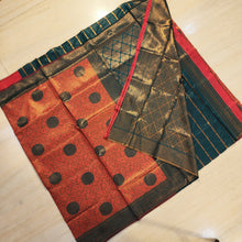 Soft Silk Saree With Blouse, folded fabric with green, red, and gold-toned sections featuring circular motifs and geometric diamond patterns