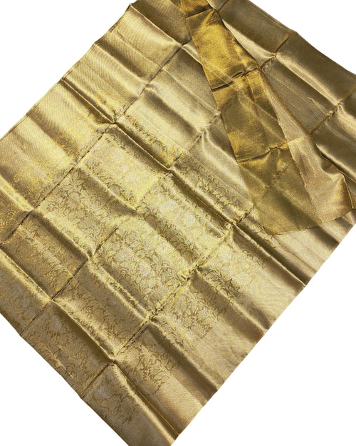 Banarasi Silk Saree With Blouse, a folded gold-toned fabric with an intricate woven pattern and a glossy finish