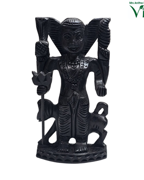 Karungali Kala Bhairava Statue, a black, matte-finished carved statue depicting a figure flanked by two small animals on a patterned base