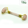 Rose Quartz Face Roller, a double-ended facial roller with two light pink stone cylinders and gold-toned metal mounts on a white background