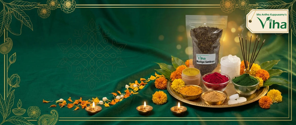 Viha pooja samagri on a brass plate: Mooligai Sambrani (herbal dhoop) pouch, Pachai Karpooram (camphor), Swamy Thilagam powder, kumkum, Kubera green kumkum, turmeric and sandal powder, incense sticks and small agal vilakku (oil lamps) with marigolds in a gold-framed banner