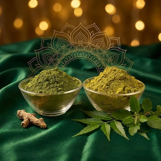 Henna and indigo hair dye powders in glass bowls with neem leaves, tulsi (holy basil) and a dried herb root on green velvet