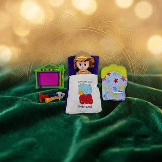 Doll in a baby sleeping bag, baby teether mitten, magic drawing slate and toy horn on green velvet
