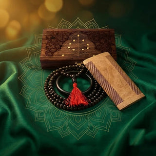 Carved wooden box, Karungali (ebony wood) mala with red tassel, Karungali bangle and neem wood comb on green velvet