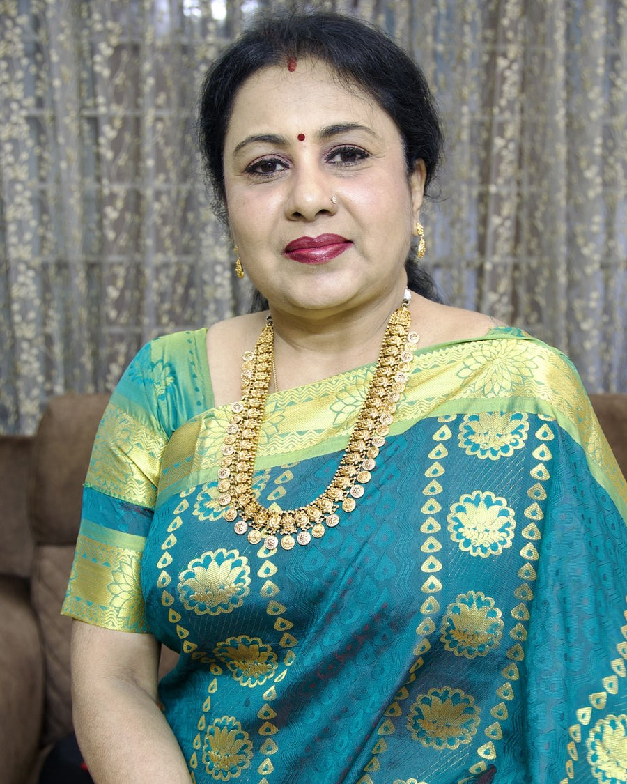 Mrs Anitha Kuppusamy, founder of Viha, in a teal and gold silk saree