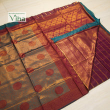 Soft Silk Saree With Blouse, folded fabric featuring a green and magenta surface with gold-toned patterned borders and circular motifs