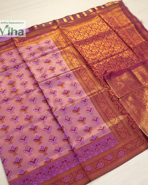 Soft Silk Saree With Blouse, a folded pink textile featuring gold-toned patterned borders and repeating floral motifs