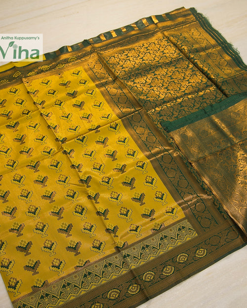 Soft Silk Saree With Blouse, a folded yellow and green textile with gold-toned woven patterns and borders