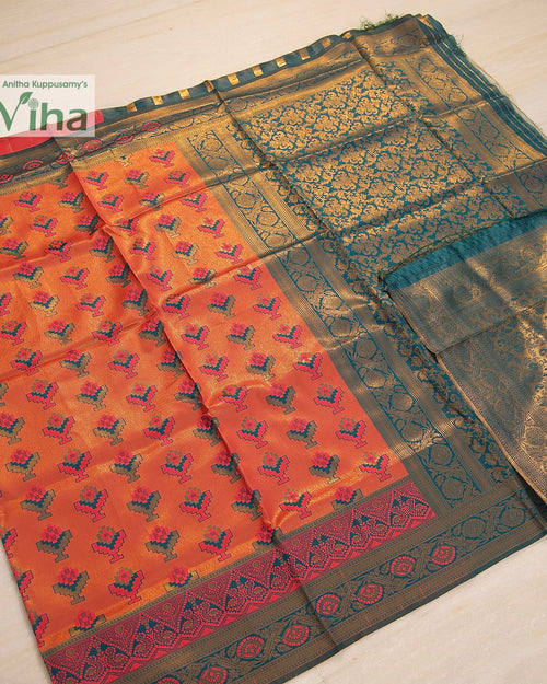 Soft Silk Saree With Blouse, a folded orange-and-teal fabric with woven floral patterns and gold-toned borders