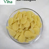 Bat Fryums with pale yellow tennis racket-shaped pieces in a glass bowl