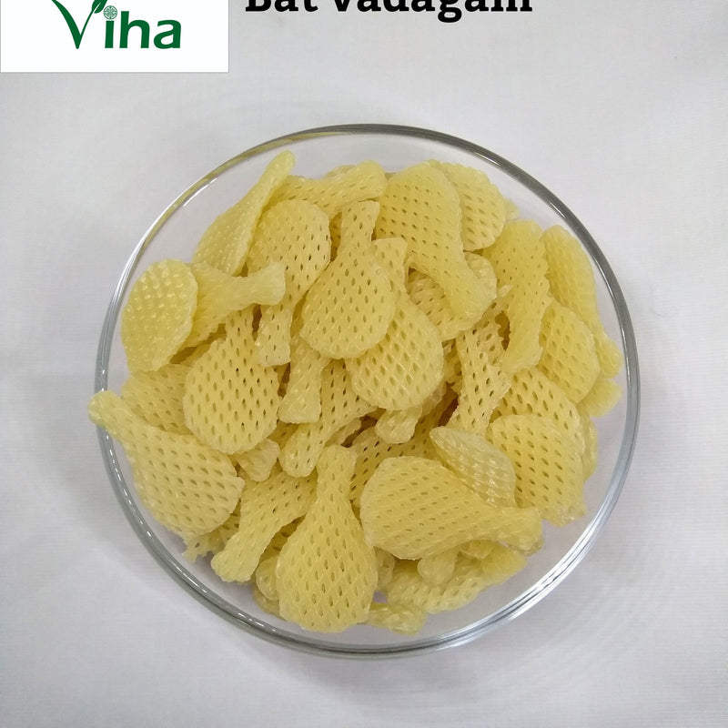 Bat Fryums with pale yellow tennis racket-shaped pieces in a glass bowl