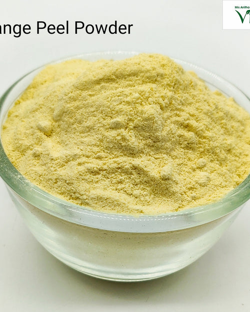 Orange Peel Powder, a glossy clear round glass bowl filled with pale yellow powder centered on a white surface
