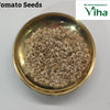 Tomato Plant Seeds / Thakkaali Vidhaigal, a gold-toned round bowl filled with numerous small pale beige seeds