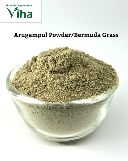 Arugampul Powder / Bermuda Grass Powder, mounded green-grey powder in a clear glass bowl