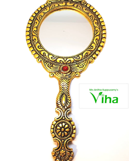 Elegant Framed Handheld Mirror, gold-toned hand mirror featuring an ornate frame with one red stone and a central circular mirror plate
