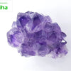 Amethyst Rock Stone, a cluster of glossy, translucent purple crystalline points featuring multiple facets and a rugged base against a plain background
