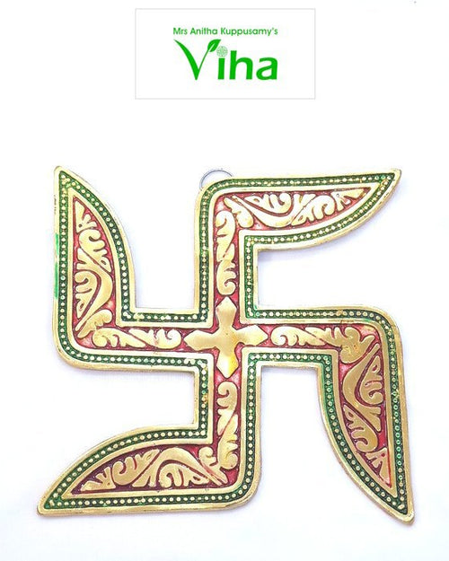 Swastik Wall Hanging, a gold-toned and red swastika emblem with green beaded borders and embossed floral patterns