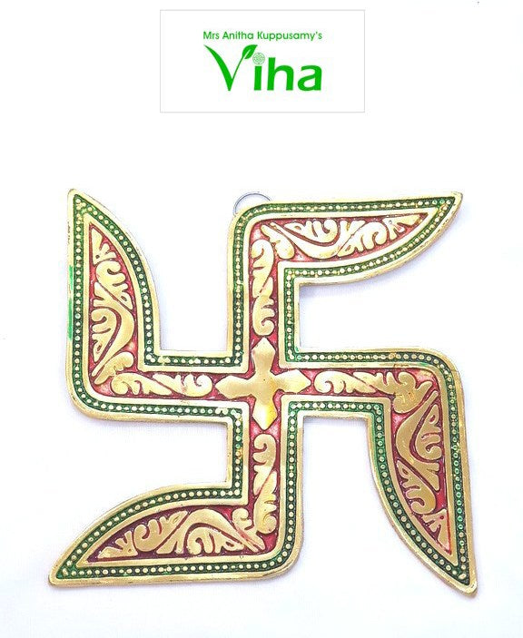 Swastik Wall Hanging, a gold-toned and red swastika emblem with green beaded borders and embossed floral patterns