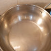 Silicon Heat Resistant Anti-Pot Holder, a silver-toned metal pot held by two blue silicone mitts on a counter