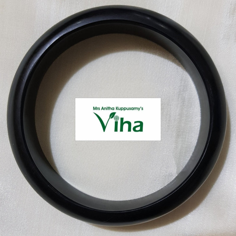 Karungali Wood Bangle, a single smooth black circular bangle with a rounded profile against a textured white fabric background