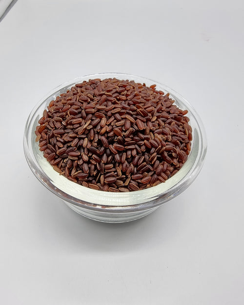 Poongar Rice - Organic, in a glass bowl filled with reddish-brown grains