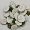 21 Mini Green Gomathi Chakram Set, a pile of spiral-patterned white and green shell-like stones