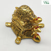 Triple Tortoise, three stacked gold-tone tortoises with engraved shell patterns and red gem eyes