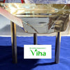 Multi Purpose Abishega Stand, a golden metal leaf-shaped tray on three straight tube-shaped legs standing on blue fabric