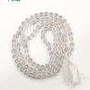 Sphatik Mala, a beaded necklace of multiple glossy clear spheres ending in a white tassel