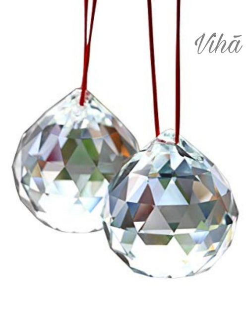 Egyptian Crystal Ball, a pair of faceted clear crystal balls hanging from red cords