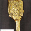 Rectangle Shape Mirror, a gold-toned metal object with a flat, decorated handle and patterned rectangular head, on dark fabric