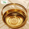 Brass Pooja Flower Basket, a glossy gold-toned metal bowl featuring a hinged handle, fluted interior, and an embossed floral medallion at the base