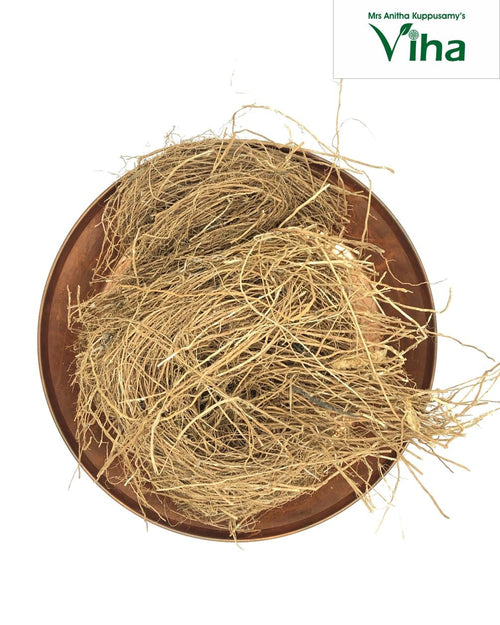 Vetiver, round copper-colored metal tray filled with a tangled cluster of light brown fibrous roots
