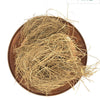 Vetiver, round copper-colored metal tray filled with a tangled cluster of light brown fibrous roots
