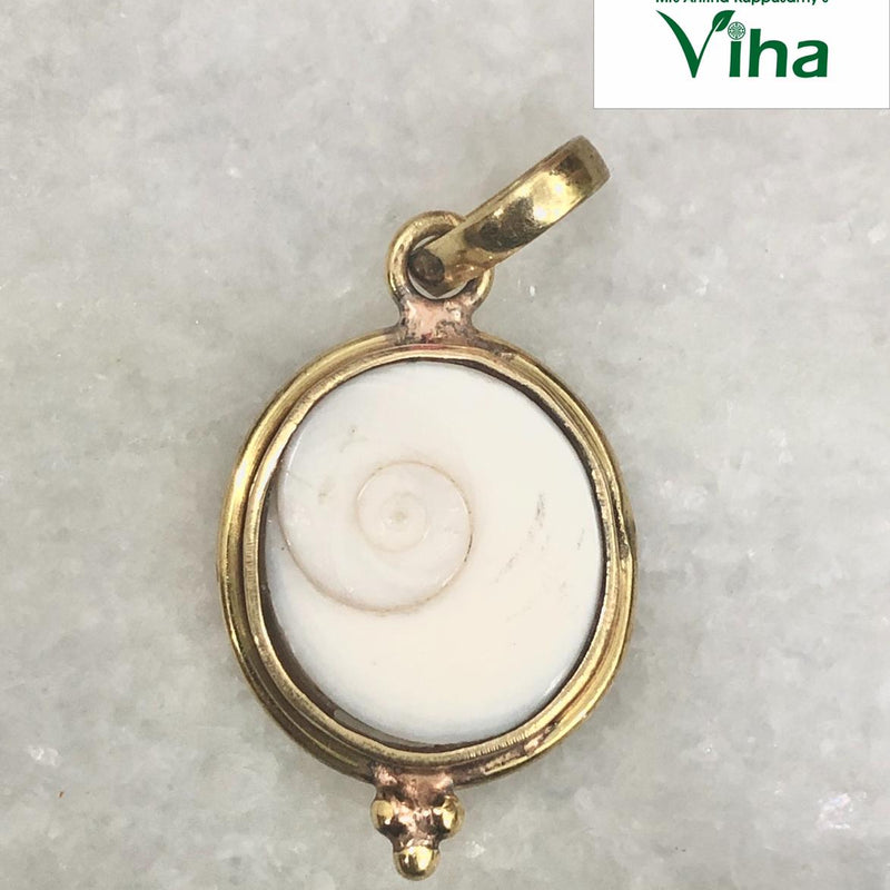 Gomathi Chakra Pendant with Brass frame, a shiny gold-toned pendant holding a round white shell piece with one brown spiral