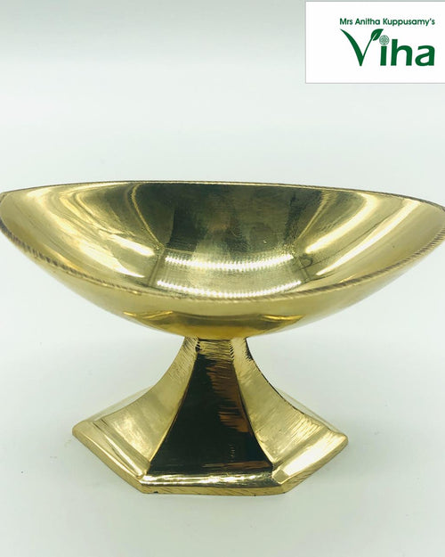 Viboothi Madakku, brass oval bowl with pointed ends, on a flared hexagonal pedestal foot