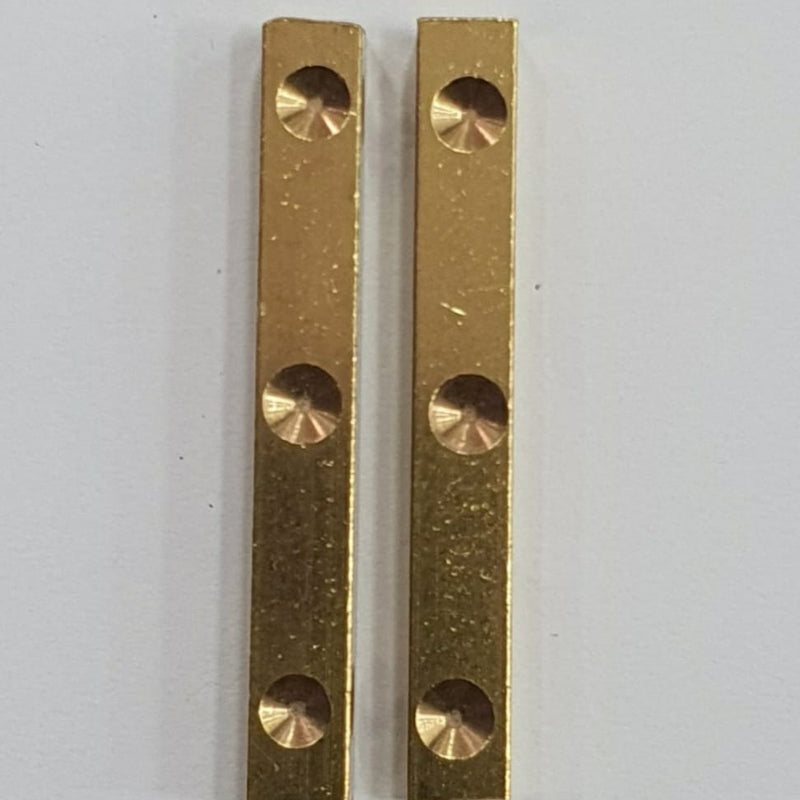 Dhayakattai (Brass), two vertical gold-toned rectangular metal strips with three circular countersunk holes each