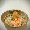 Mahalakshmi Mini 22 ct Gold Lamp - 22 Carat Gold, a metallic-toned, scalloped bowl holding rice grains and a lit gold-toned figurine-topped lamp